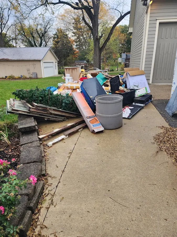 Dumpster being loaded with debris for 12 Yard Dumpster Rental in Union Gap